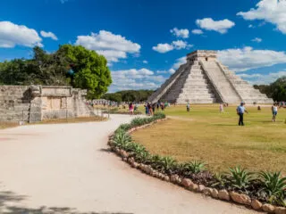 CHICHEN ITZA, MEXICO - Crowds of tourists visit the Kukulkan pyramid at the archeological site Chichen Itza.