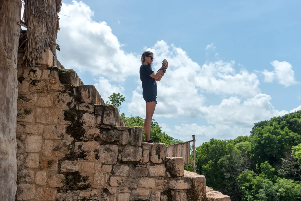 Traveler woman taking photos of Ek Balam ruins in Yucatan, Mexico