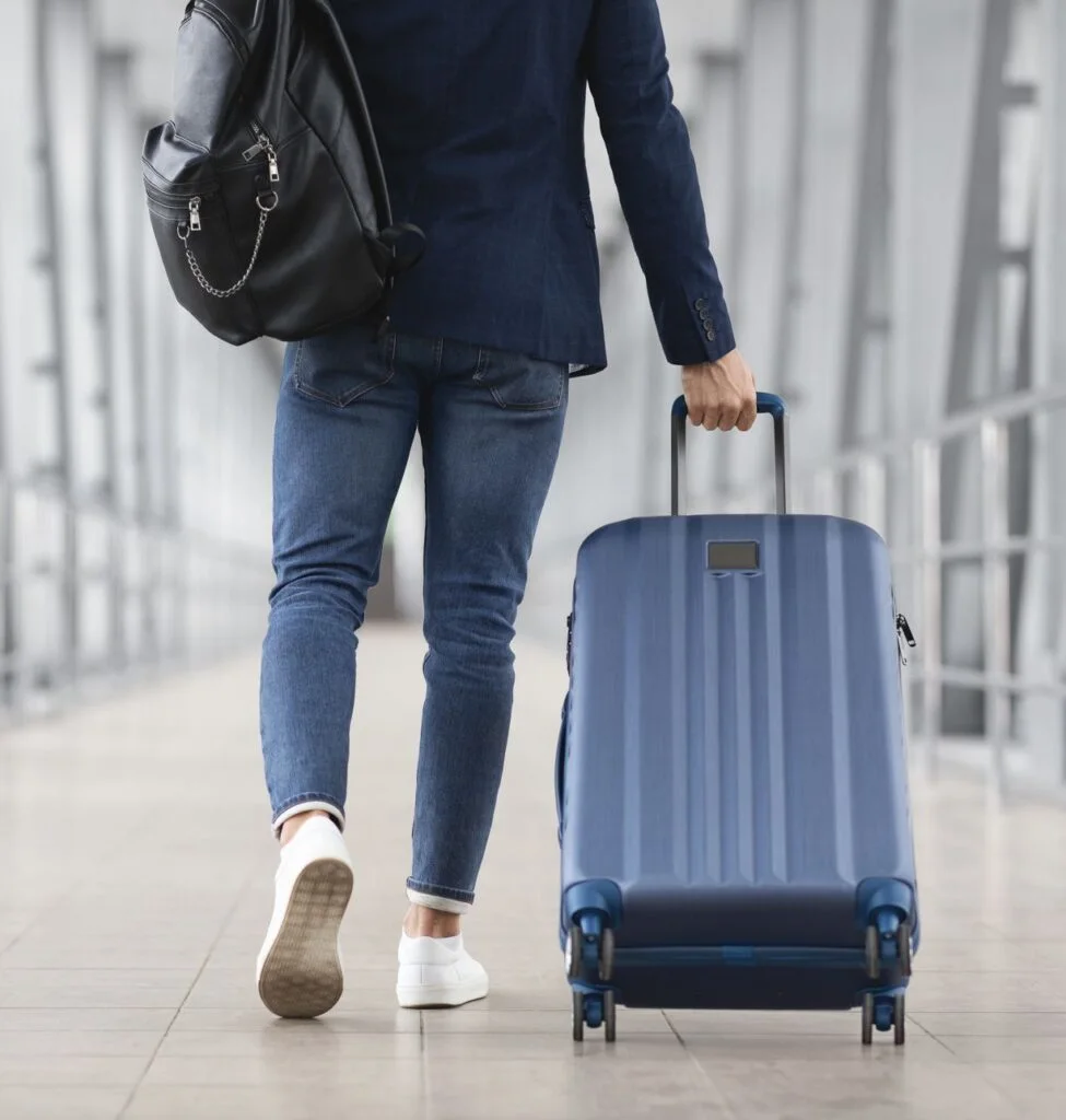 man at airport with luggage