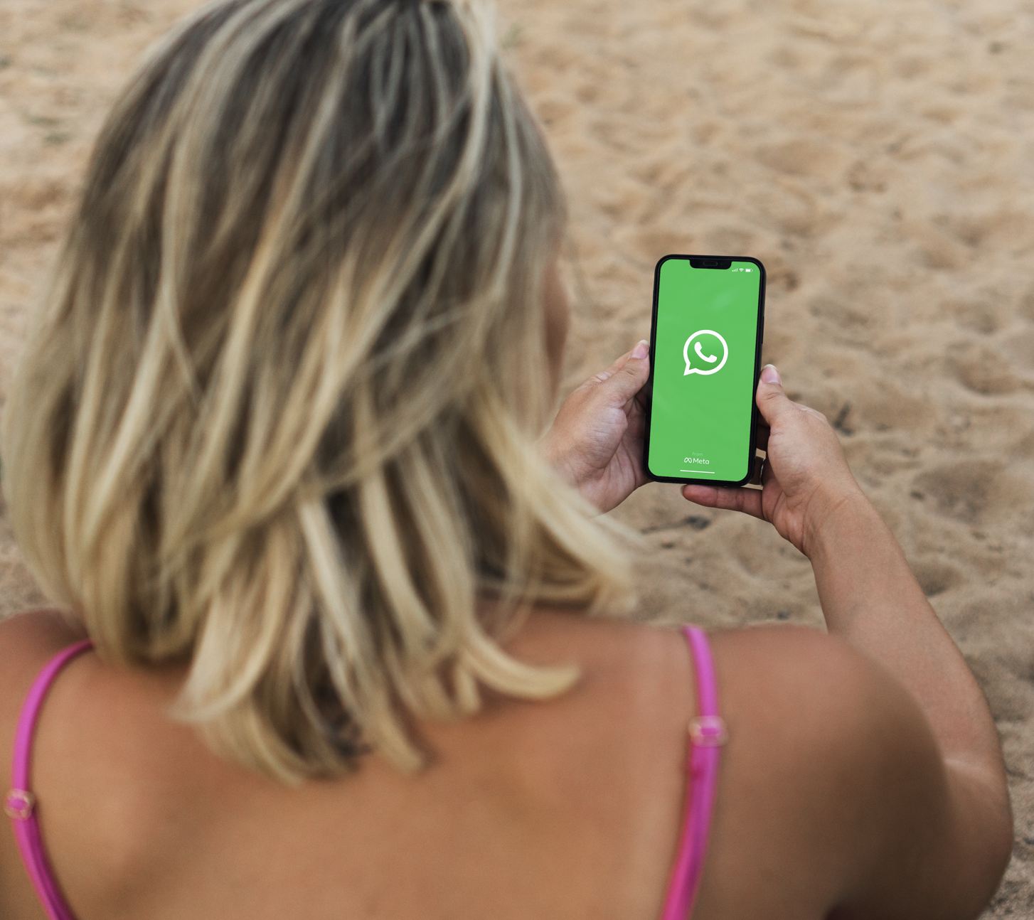 2025Woman using whatsapp on beach