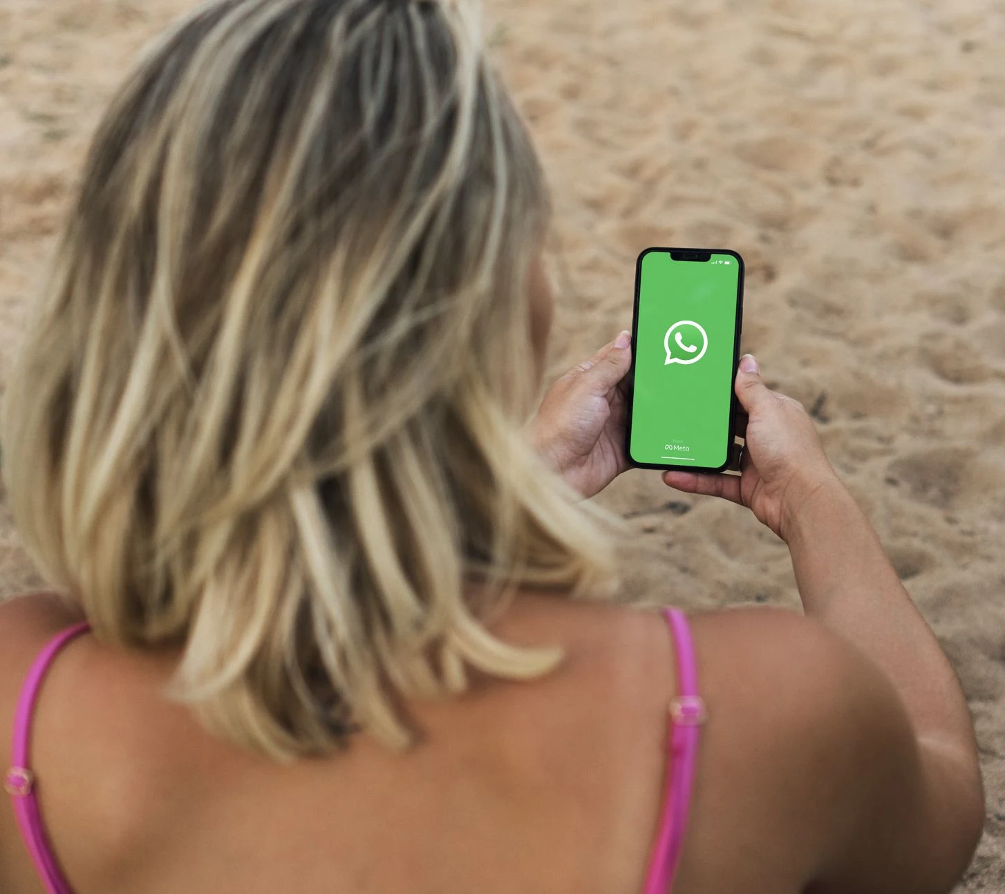 2025Woman using whatsapp on beach