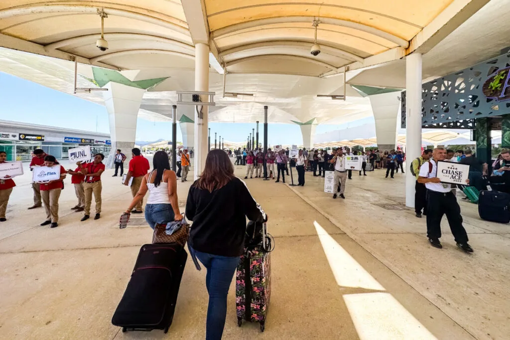 People walking toward taxis and airport pickups at Cancun Airport