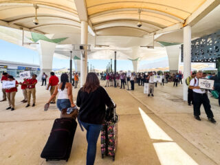 People walking toward taxis and airport pickups at Cancun Airport