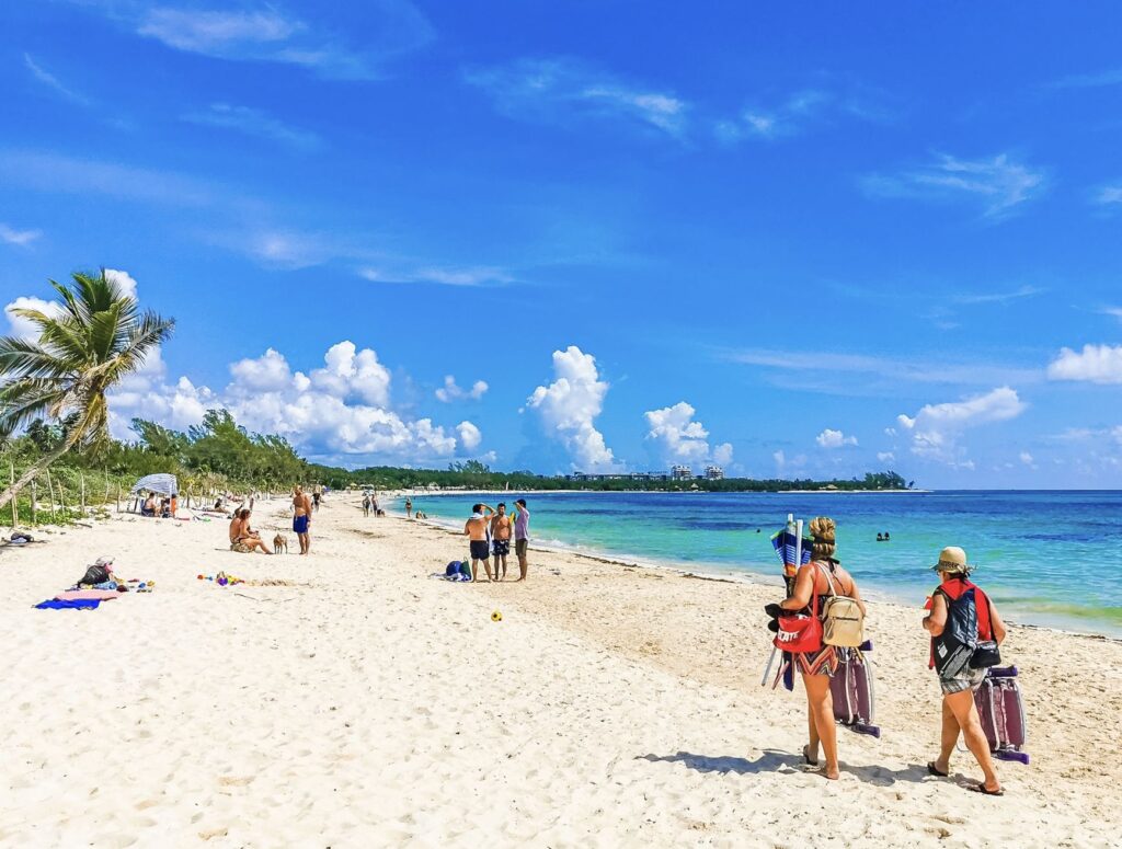 Tourists walking on beach in Playa