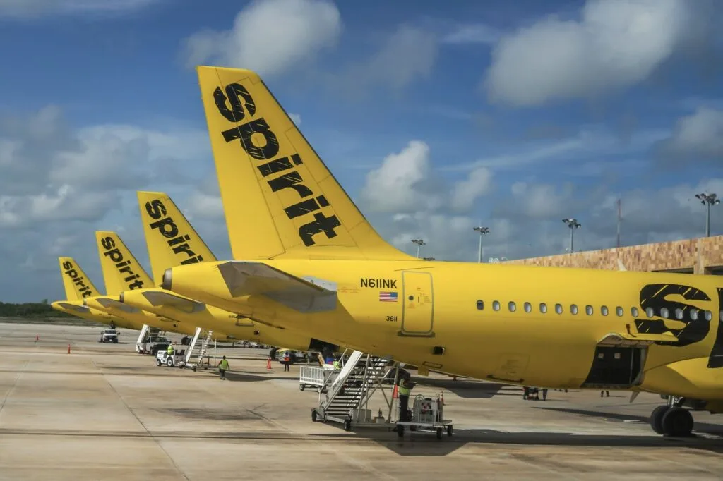 Spirit Airlines planes lined up at Cancun Airport