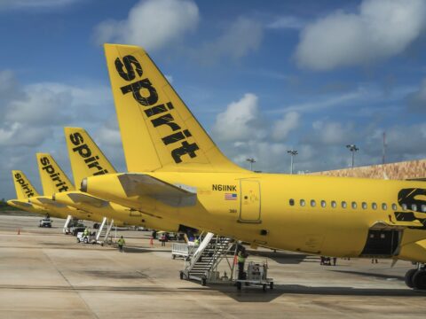 Spirit Airlines planes lined up at Cancun Airport