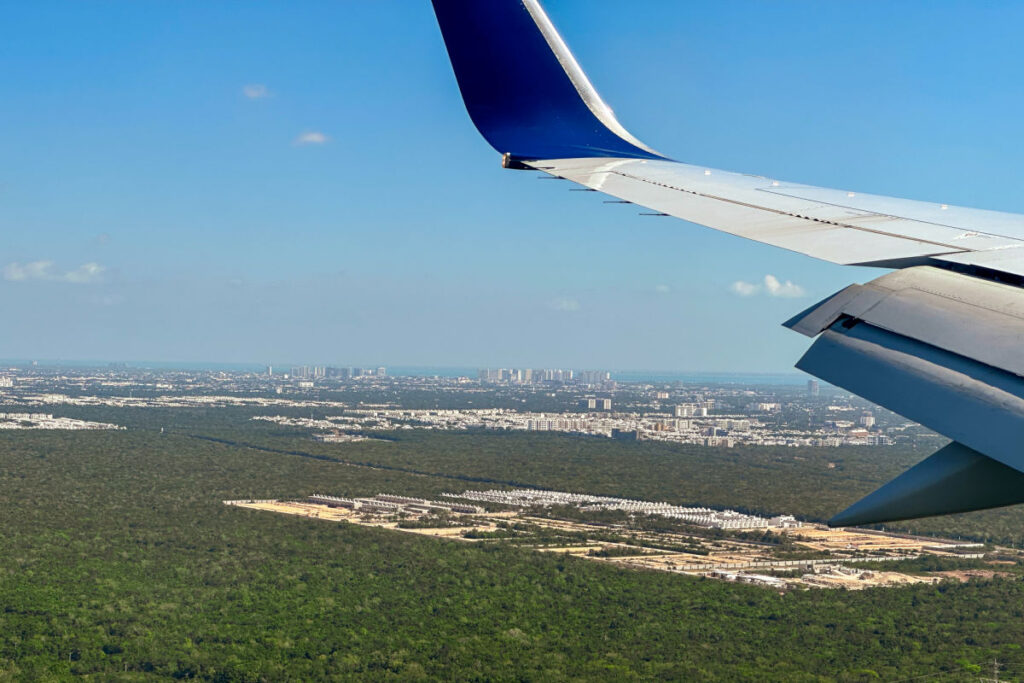 View flying into Cancun Airport from the window of plane