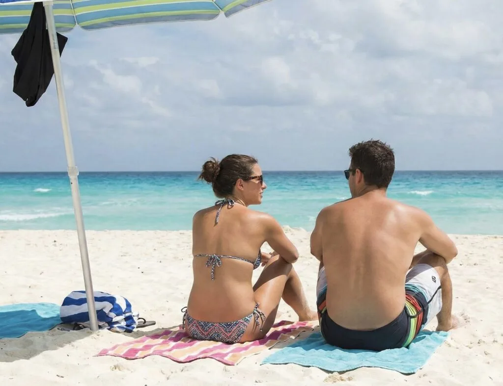 Couple sitting on Cancun beach