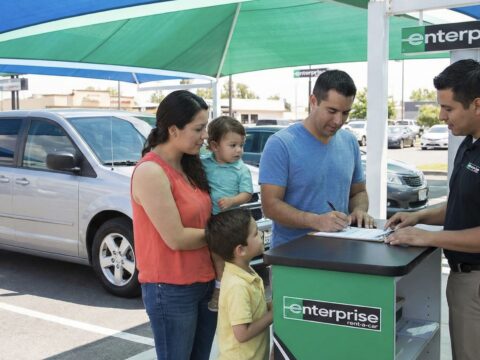 Family renting car at rental car company van Enterprise