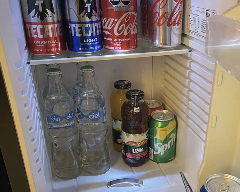 Four bottles of water in mini bar fridge in Cancun Hilton Original Photo By Trevor Kucheran