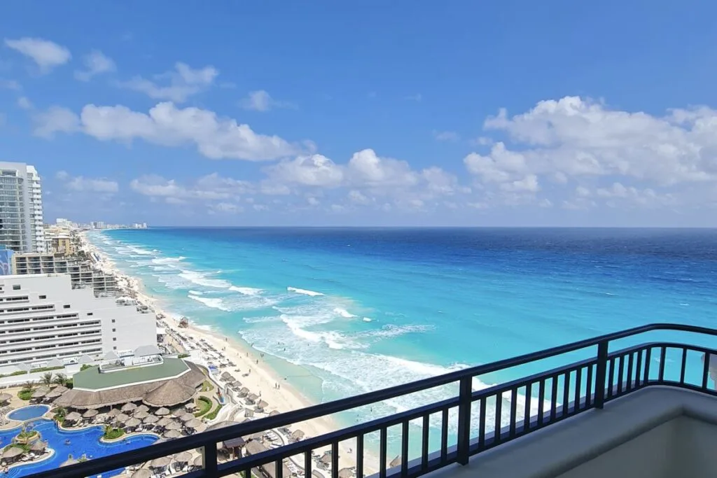 View From Balcony at JW Marriott overlooking white sand beach and aqua blue water in Cancun. Original Photo by Trevor Kucheran