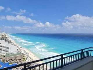 View From Balcony at JW Marriott overlooking white sand beach and aqua blue water in Cancun. Original Photo by Trevor Kucheran