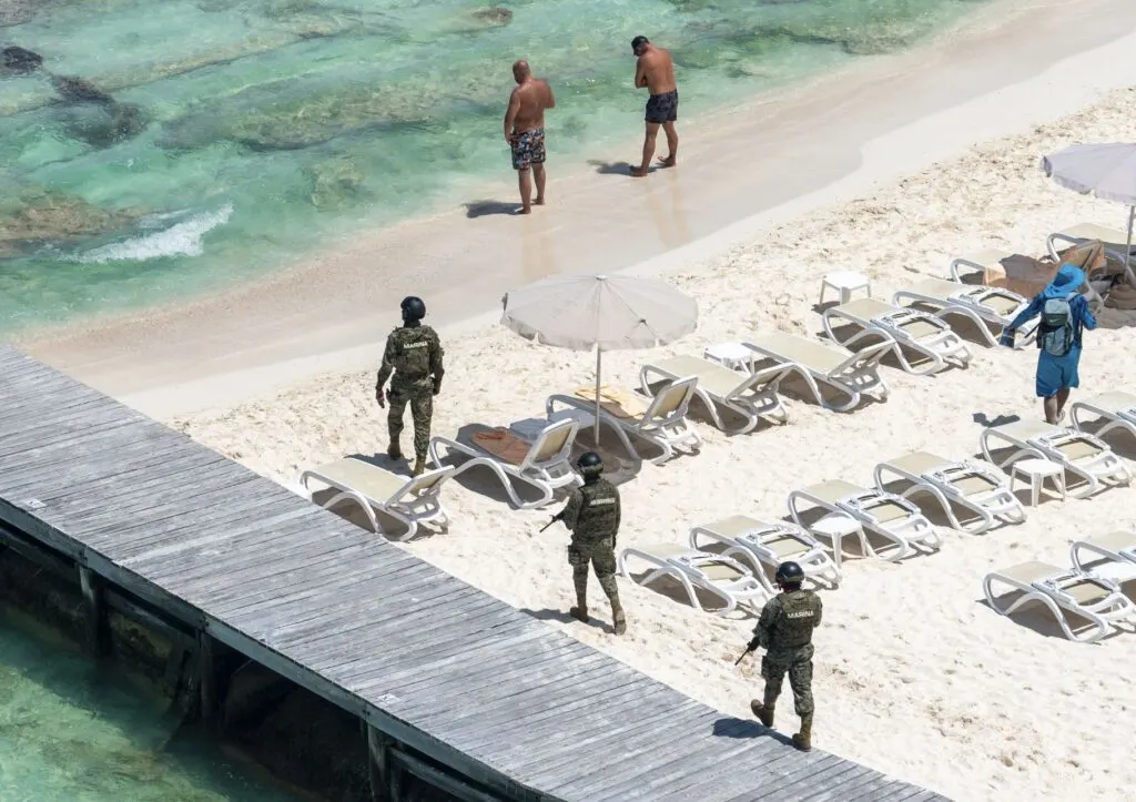 Military soldiers patrol beach in Cancun