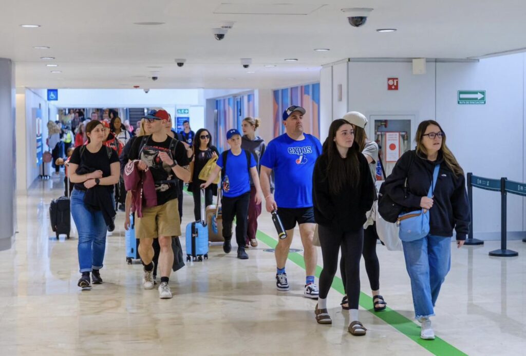 Travelers Arrive At Cancun Airport