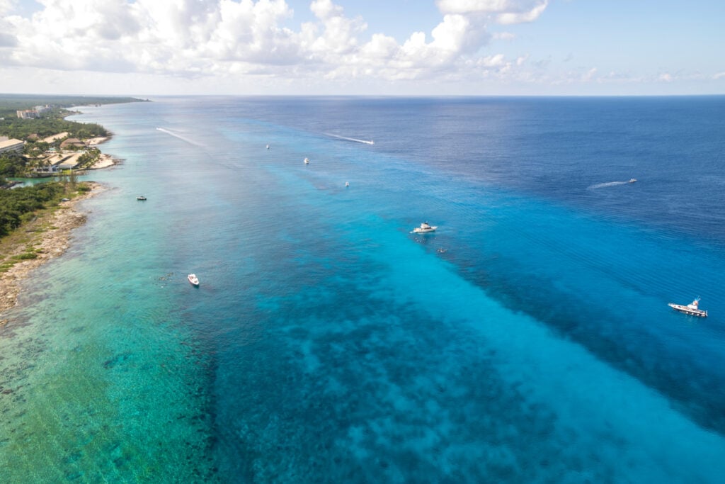 Aerial view of boats on water heading to Palancar Reef in Cozumel Mexico