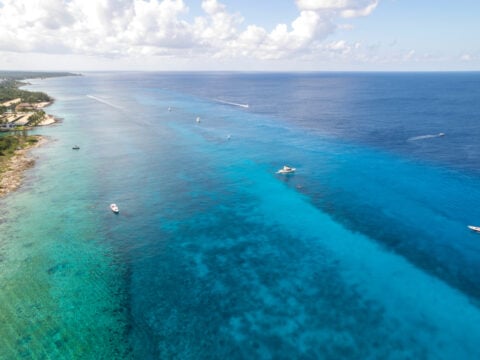 Aerial view of boats on water heading to Palancar Reef in Cozumel Mexico