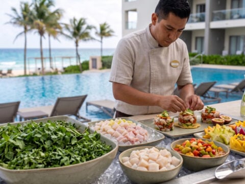 Man making Salad at a salad bar at cancun resort