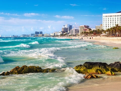 White sand beach on the blue Caribbean sea in Cancun city downtown, Mexico
